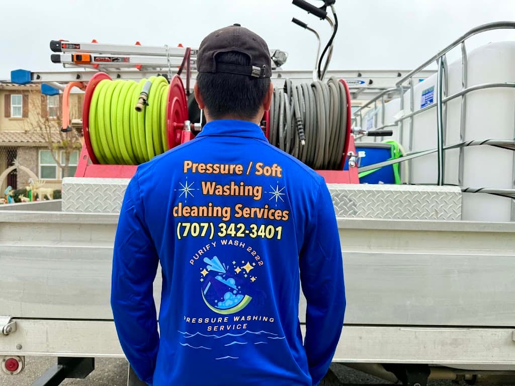 Purify Wash 2222 technician in branded uniform standing by loaded service truck